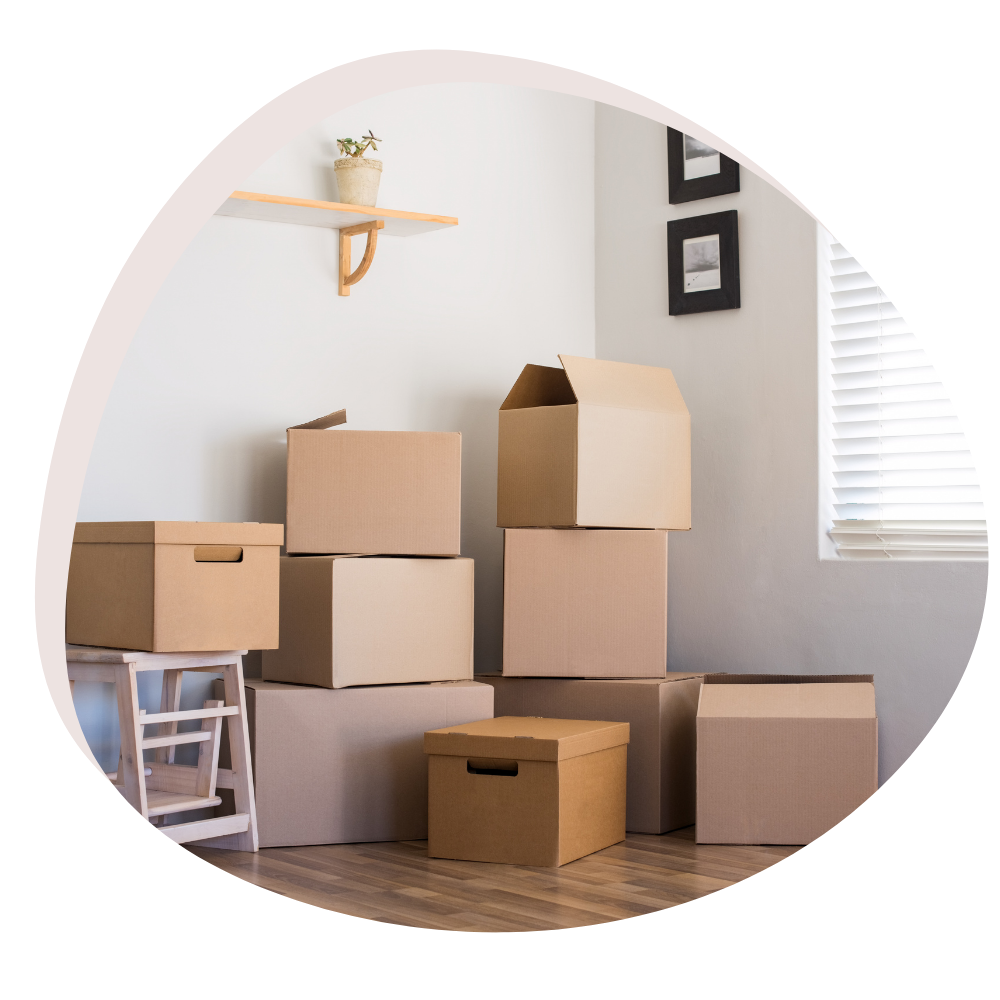 Pile of unpacked cardboard boxes in a room suggesting a moving scene.